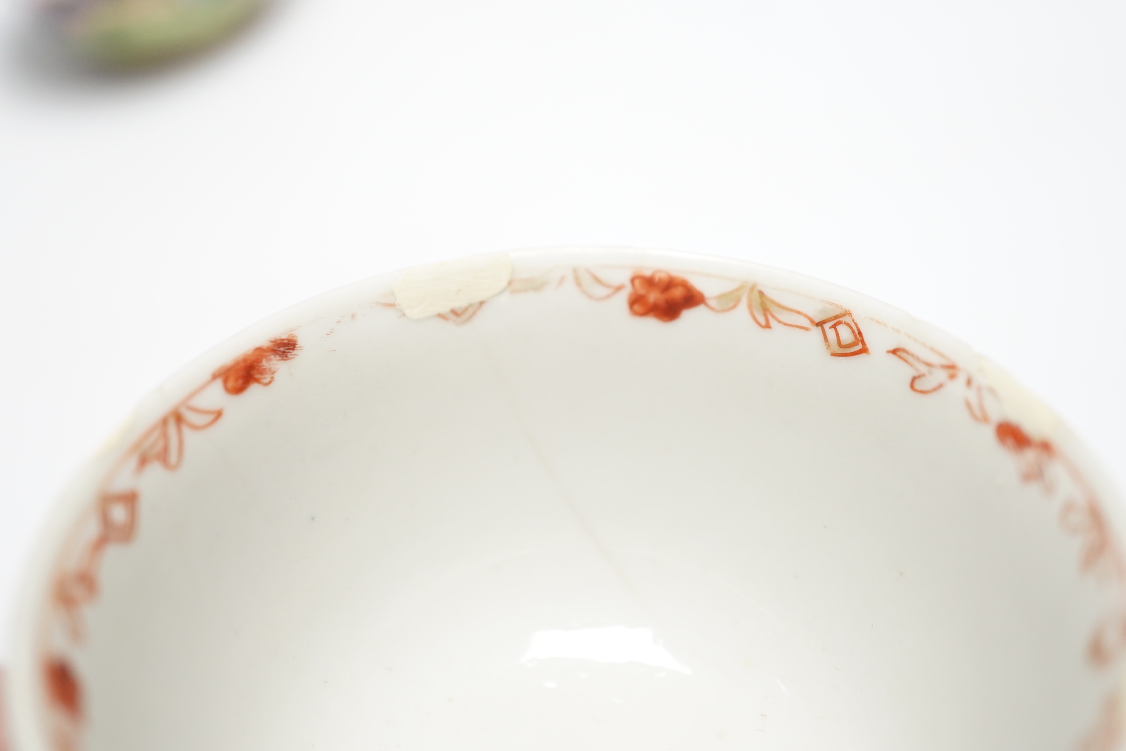 A Chinese Canton enamel tea bowl and cover, and a porcelain tea bowl, largest 8cm high